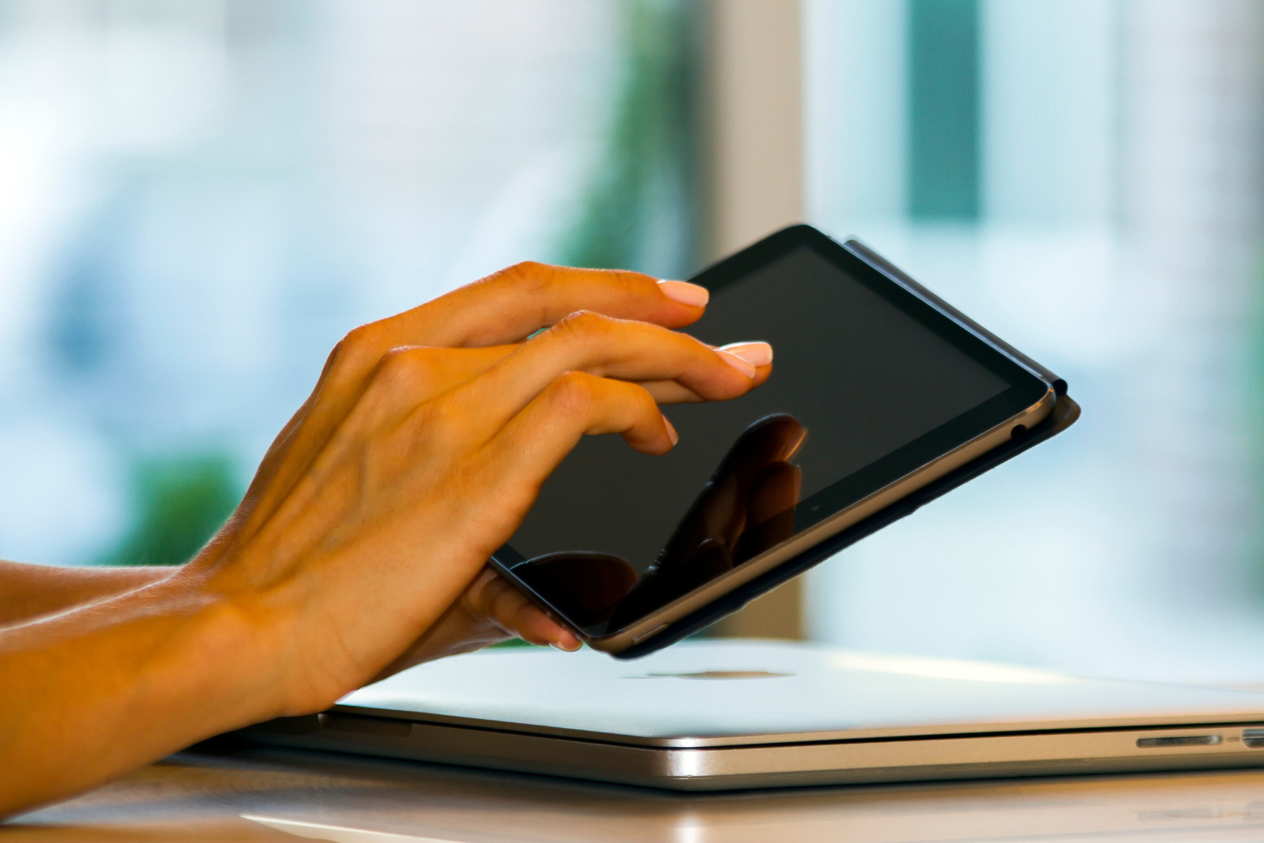 Woman using digital tablet at home, closeup, lifestyle